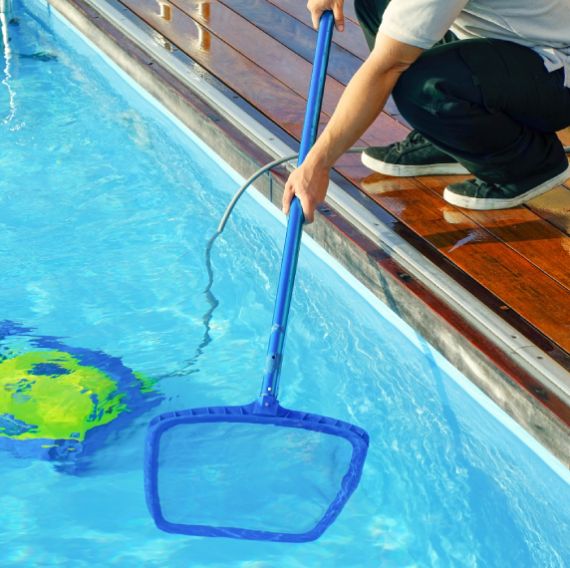 Professional cleaning out pool with net